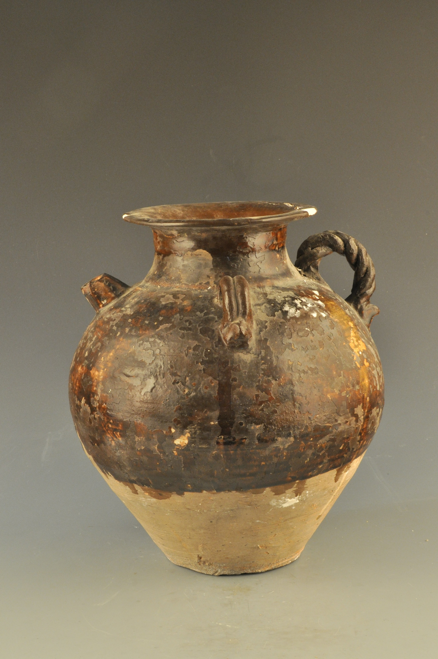 Brown Glazed Pot Made in the Tang Dynasty with Twisted Knobs, Open Mouth and Double Handles